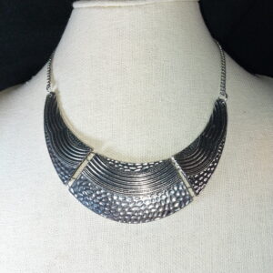 A unique Egyptian style silver tone necklace.