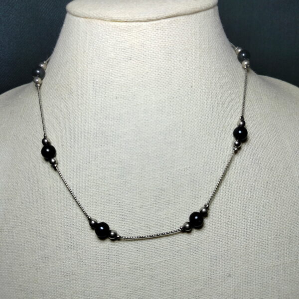 A pretty black pearl with silver beads necklace