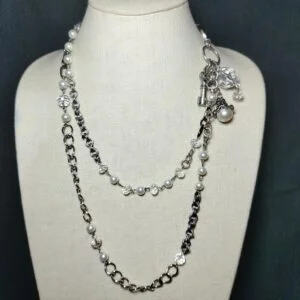 A pretty silver tone clear plastic crystal and white pearl necklace