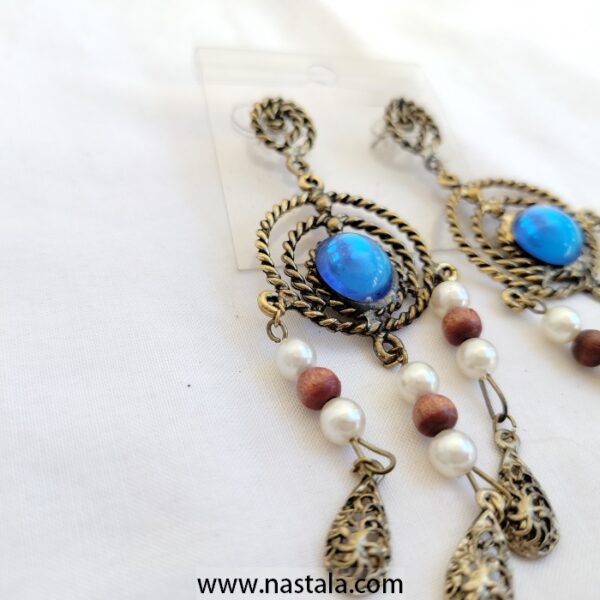 A pair of vintage-style earrings with blue accents and dangling beads | أقراط بتصميم قديم مع لمسات زرقاء وخرز متدلي - Image 4