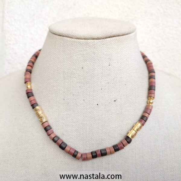 A necklace with colorful cylindrical beads and golden accents | قلادة مع خرز أسطواني ملون وتفاصيل ذهبية