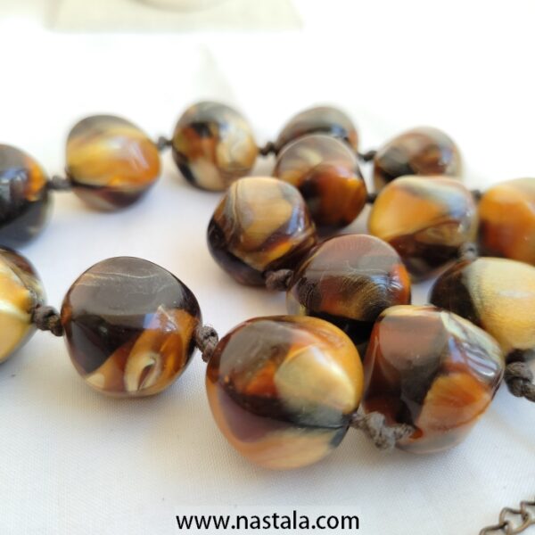 A necklace with large, round plastic beads in warm tones | قلادة من خرز بلاستيكي كبير ودائري بألوان دافئة - Image 3
