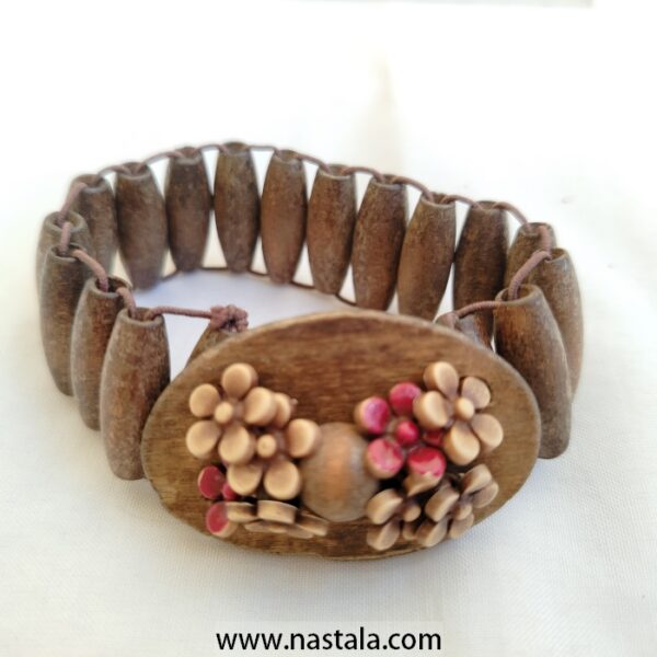 A wooden bracelet with floral embellishments | سوار خشبي مع زينة زهرية