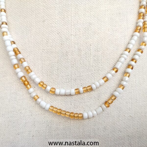 A double-strand necklace with white and gold beads | قلادة ذات خيطين من الخرز الأبيض والذهبي - Image 3