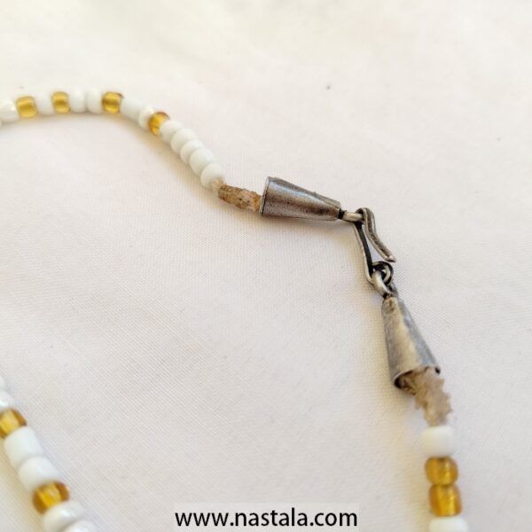 A double-strand necklace with white and gold beads | قلادة ذات خيطين من الخرز الأبيض والذهبي - Image 4