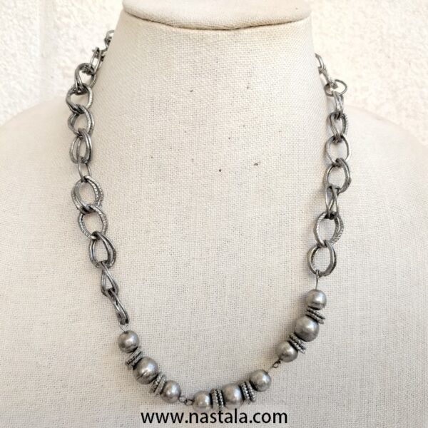 A silver-tone necklace with linked chains and round beads | قلادة بتصميم سلسل فضي مع خرز دائري