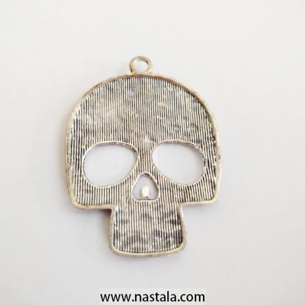 A decorative skull pendant with floral patterns | قلادة على شكل جمجمة مع نقوش زهرية - Image 2