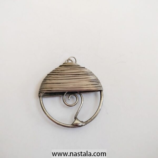 A minimalist silver pendant with an abstract design | قلادة فضية بسيطة بتصميم تجريدي
