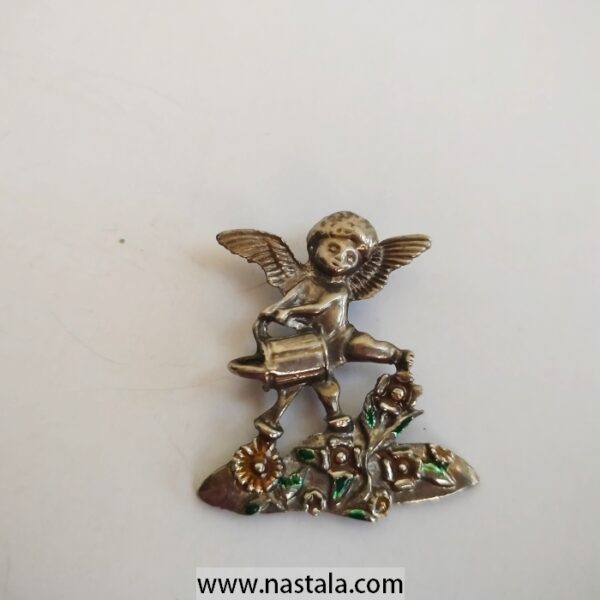 A vintage angel brooch with colorful floral details | دبوس قديم بشكل ملاك مع تفاصيل زهرية ملونة